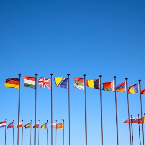 Flags of the world against blue sky