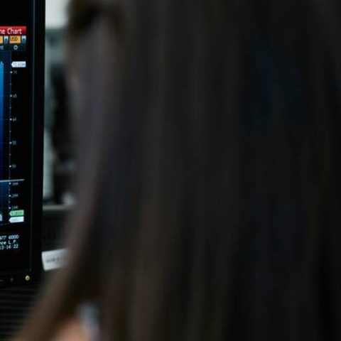 A monitor displaying a digital financial graph 