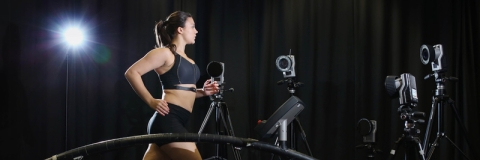Female runner on treadmill with motion capture cameras 
