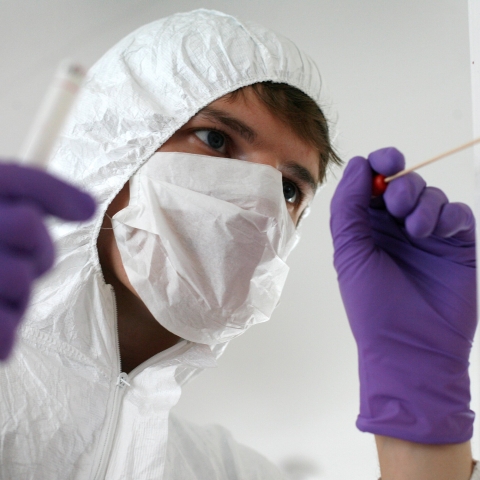 Student collects evidence sample at crime scene