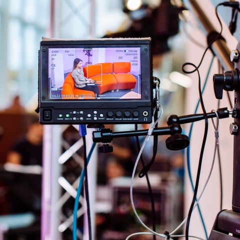 Female student presenter in TV studio at University of Portsmouth