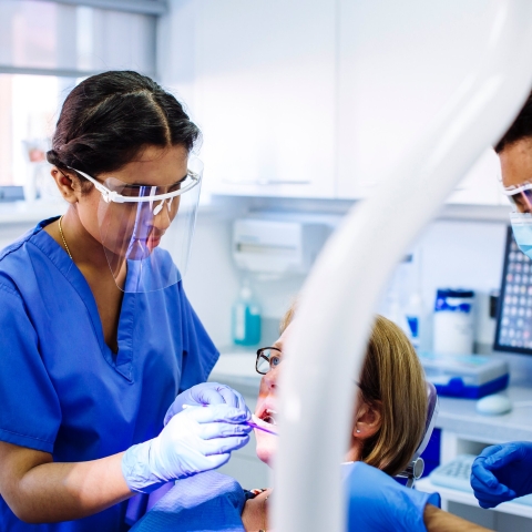 Dental nurses treating patient