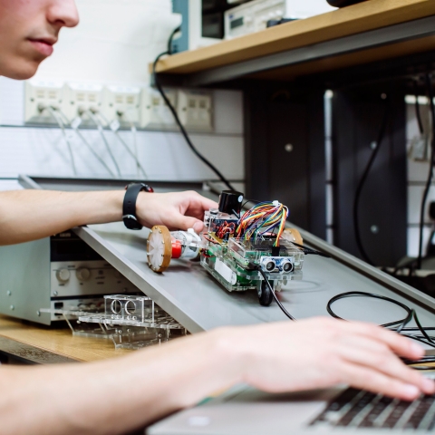 Student holding a robot