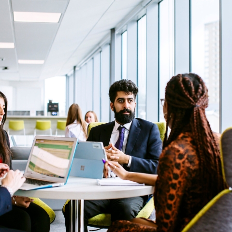 Two people sitting opposite each other in a business meeting