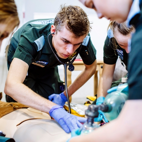 Paramedic students practicing on a manikin