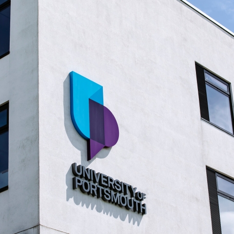 corner of University of Portsmouth building with logo