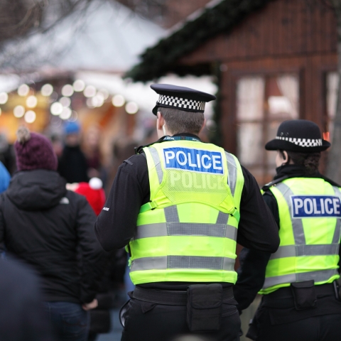 Two police officers in busy street