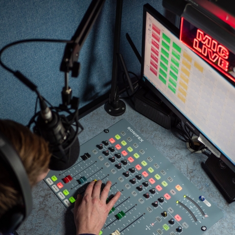 A person using a sound system with condenser microphone