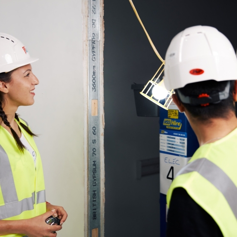 Female civil engineering student at building site