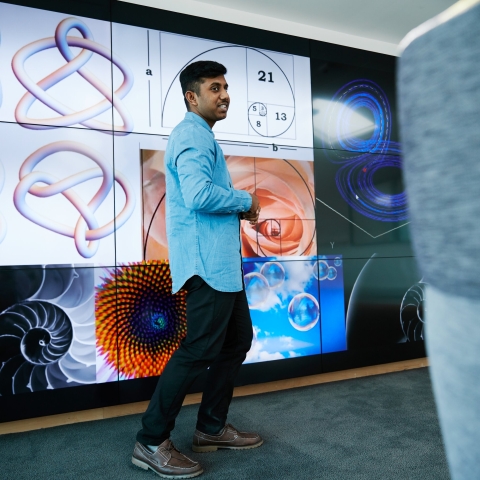 Male student giving presentation in the School of Mathematics and Physics