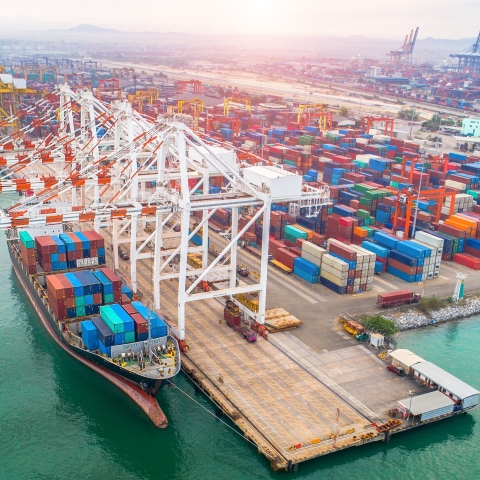 Large ship at industrial port, loading containers