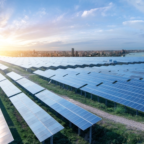 solar panel farm on the outskirts of large modern city