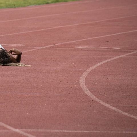 An athlete lying down on a track