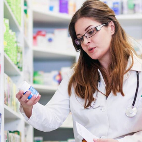 A pharmacist advising a female patient on medicine in a pharmacy