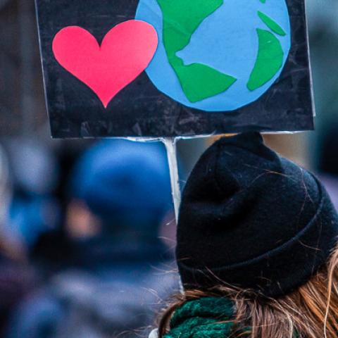 Woman holding sign at environmental march