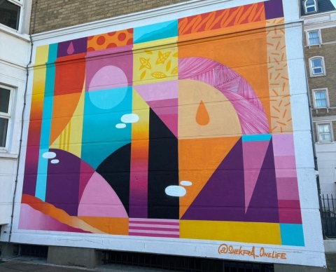 Colourful mural on the side of Rees Halls in Portsmouth for LOOKUP Festival