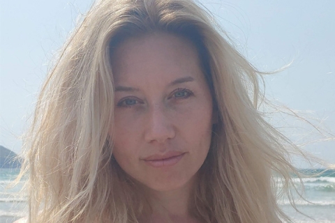 Josie Pallister on beach looking to camera for photo