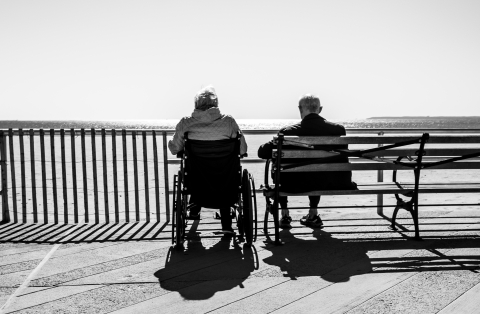 Elderly couple sitting by the beach - Photo by Bruno Aguirre on Unsplash