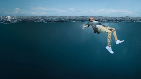 man floating in water for Float to Live campaign photo