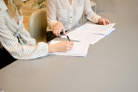 Two people sat at a desk looking at CVs