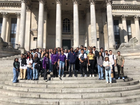 Group of people standing in front of a building.