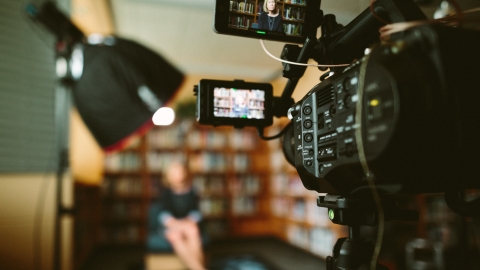 Image of a camera filming someone in the distance