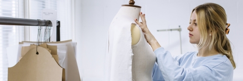 Student dressing a mannequin