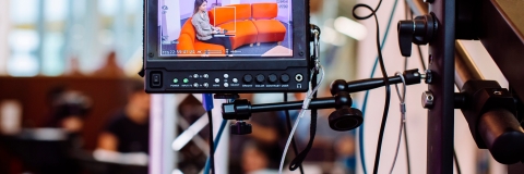 Female student presenter in TV studio at University of Portsmouth