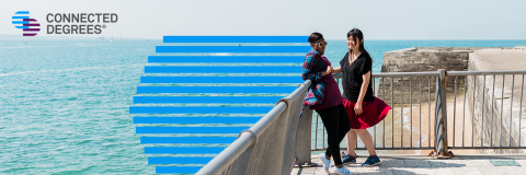 Two students at the beach with the Connected Degrees logo