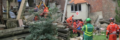 Disaster recovery team cleaning up rubble