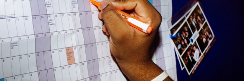 A hand writing on an academic calendar