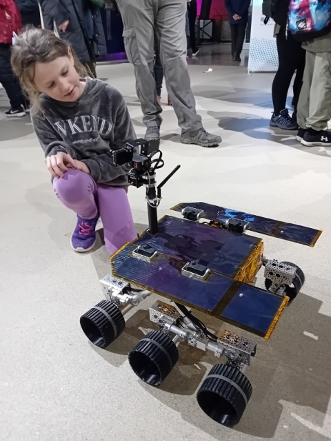Girl looking at Mars rover vehicle