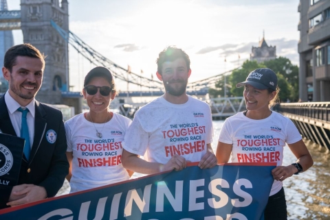 Rowers in front of Tower Bridge, London, with a Guinness World Record adjudicator