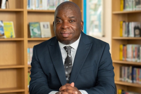 Headshot of Professor Nira Chamberlain smiling to camera