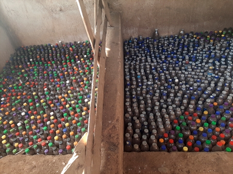 Plastic bottles filled with soil ready to be used for constructing buildings