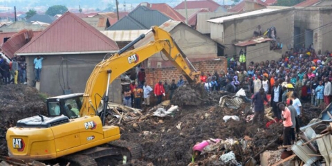 Digger clearing waste at Kiteezi landfill in Kampala after a landslide