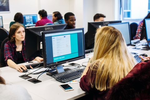 A group of students on computers in a room