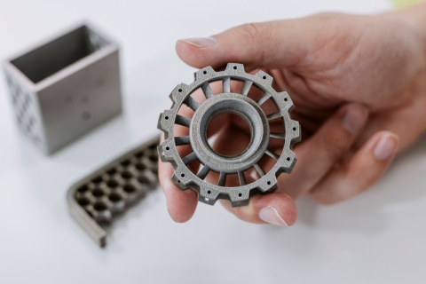 Student examines manufactured plastic composite gears at Technology Facilities