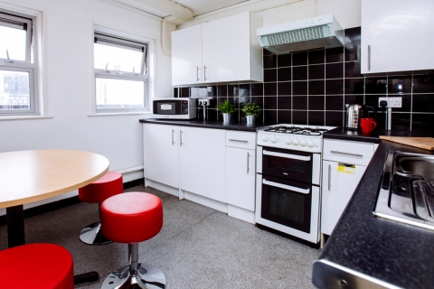 A kitchen in Bateson student halls including an over, a microwave and a sink