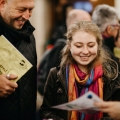 A prospective student and a parent smile at an invitation