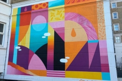 Colourful mural on the side of Rees Halls in Portsmouth for LOOKUP Festival