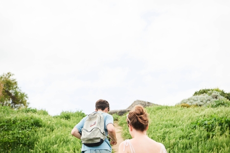 Two students walking through fields